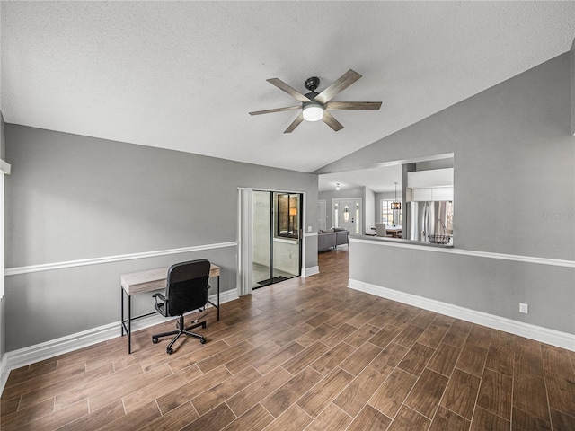 unfurnished office featuring lofted ceiling, ceiling fan, a textured ceiling, baseboards, and wood tiled floor