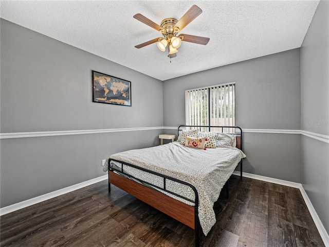 bedroom with a textured ceiling, ceiling fan, wood finished floors, and baseboards