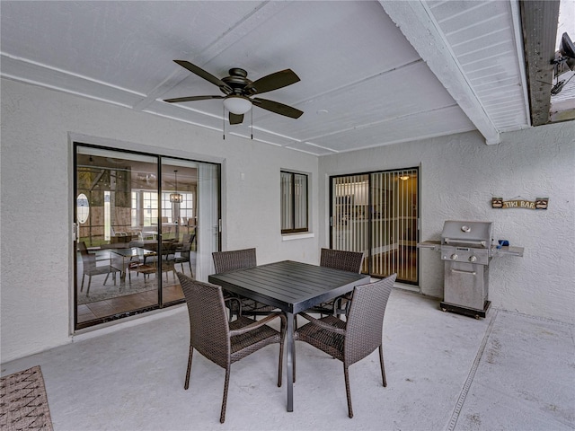 view of patio featuring ceiling fan, outdoor dining space, and area for grilling