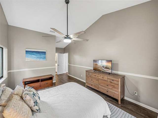 bedroom with a ceiling fan, vaulted ceiling, baseboards, and wood finished floors