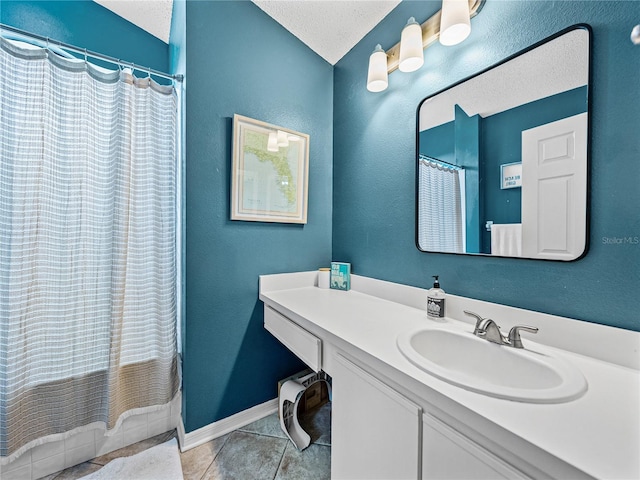 bathroom featuring baseboards, a shower with curtain, tile patterned floors, a textured ceiling, and vanity