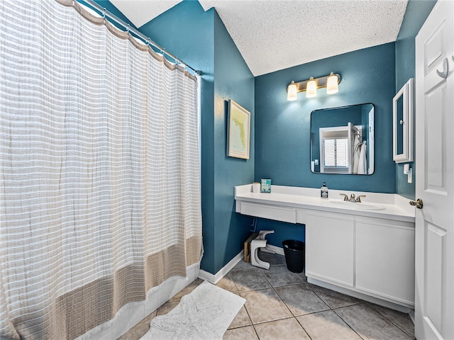 full bathroom featuring tile patterned flooring, a shower with curtain, a textured ceiling, and vanity