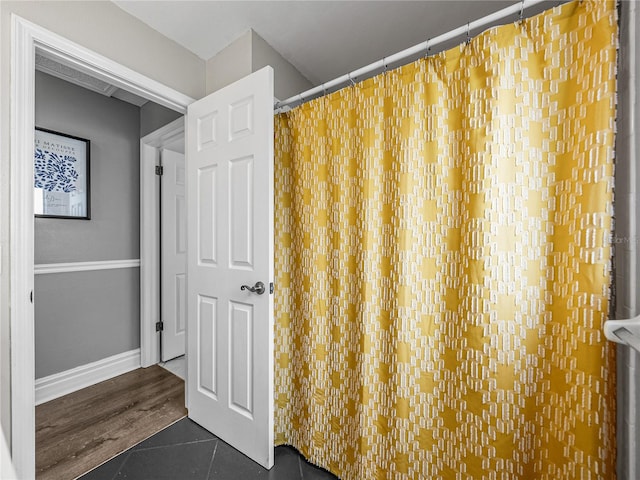 full bathroom with tile patterned flooring and baseboards