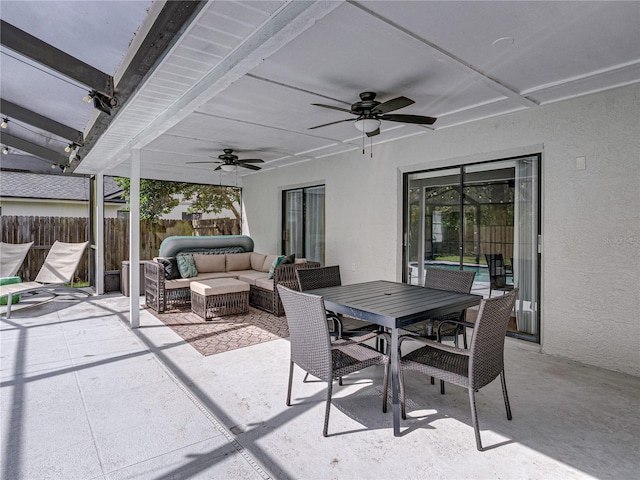 view of patio / terrace with ceiling fan, fence, an outdoor hangout area, and outdoor dining space