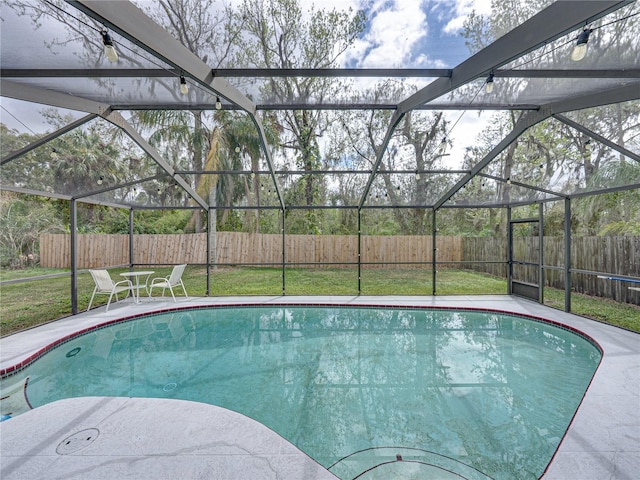 view of swimming pool featuring a lawn, a fenced backyard, a fenced in pool, and a lanai