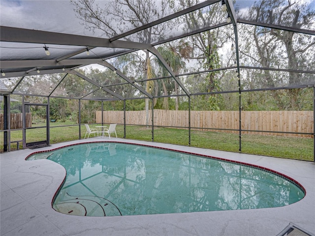 view of swimming pool with glass enclosure, a patio, a fenced backyard, a lawn, and a fenced in pool