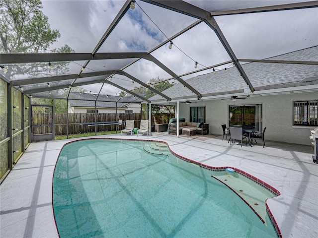 view of pool with a patio, an outdoor hangout area, glass enclosure, ceiling fan, and a fenced backyard