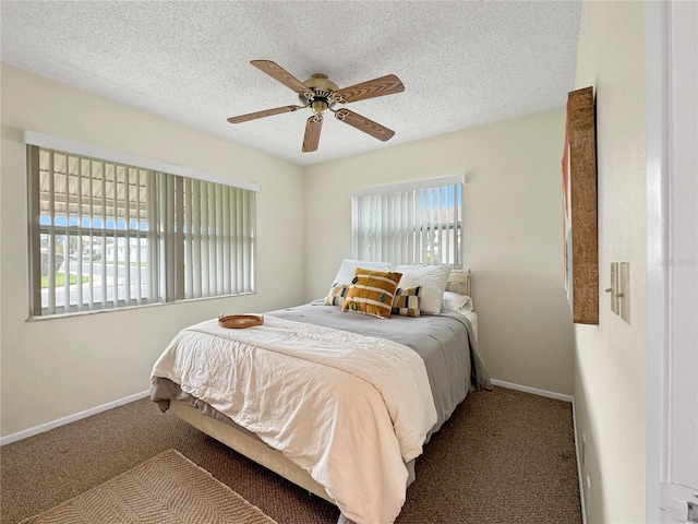 carpeted bedroom featuring a ceiling fan, baseboards, and a textured ceiling