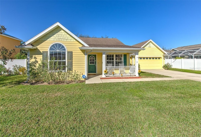 ranch-style home featuring a porch, a front yard, concrete driveway, and fence