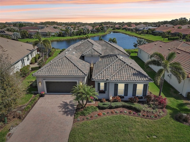 drone / aerial view featuring a water view and a residential view