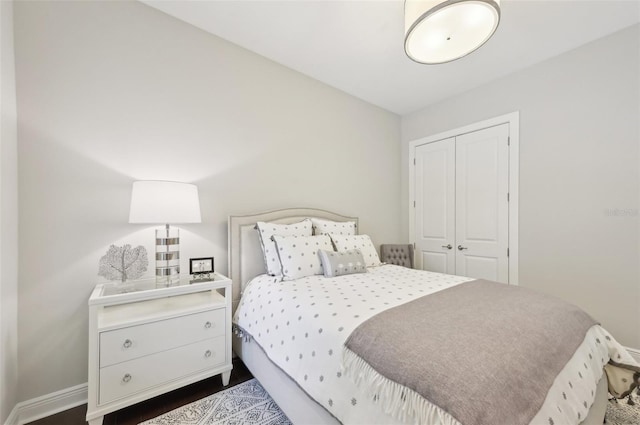 bedroom featuring a closet and baseboards