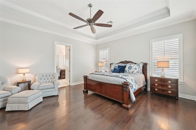 bedroom featuring baseboards, visible vents, a raised ceiling, and wood finished floors