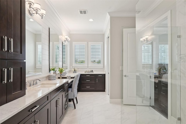 bathroom with a wealth of natural light, visible vents, and crown molding