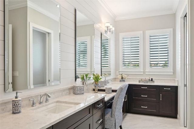 full bath with double vanity, crown molding, and a sink