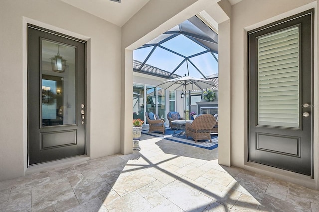 doorway to property featuring a patio and stucco siding