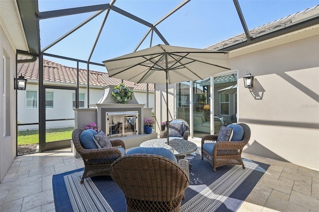 view of patio featuring glass enclosure and an outdoor living space with a fireplace