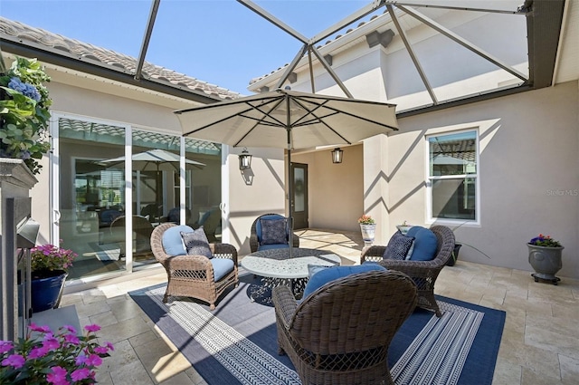 view of patio / terrace featuring glass enclosure and an outdoor living space