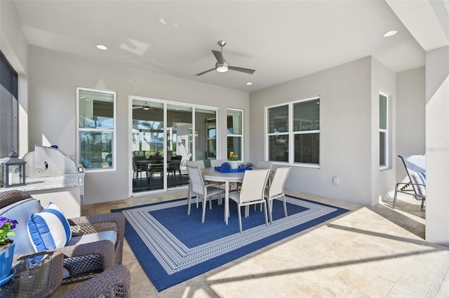 view of patio / terrace featuring outdoor dining space, exterior kitchen, and a ceiling fan