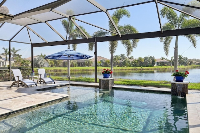 view of pool featuring glass enclosure, a patio area, and a water view