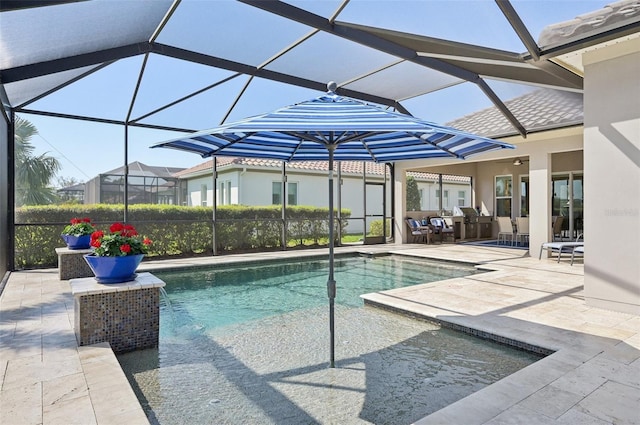 pool featuring glass enclosure and a patio