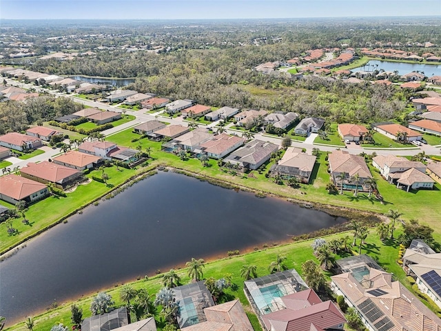 drone / aerial view featuring a water view and a residential view