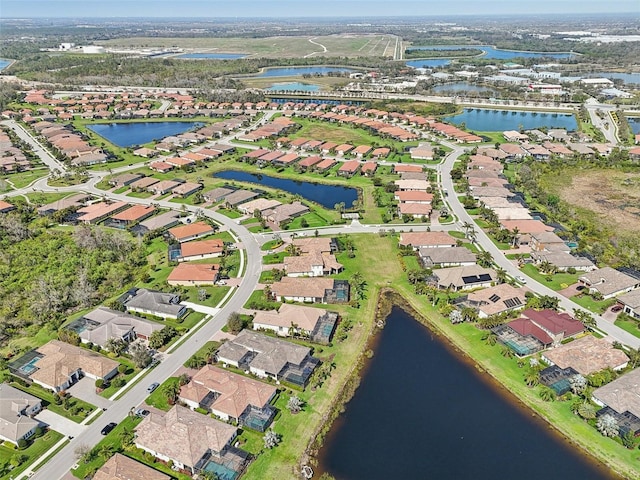 birds eye view of property featuring a water view and a residential view