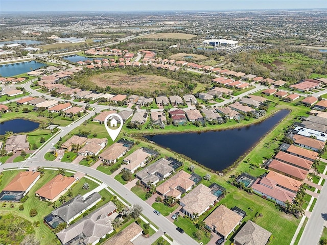 birds eye view of property with a water view and a residential view