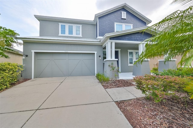 view of front of property with an attached garage, concrete driveway, and stucco siding