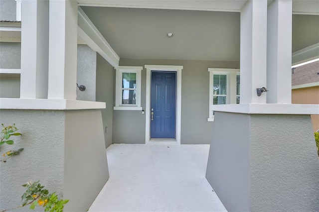 entrance to property with stucco siding