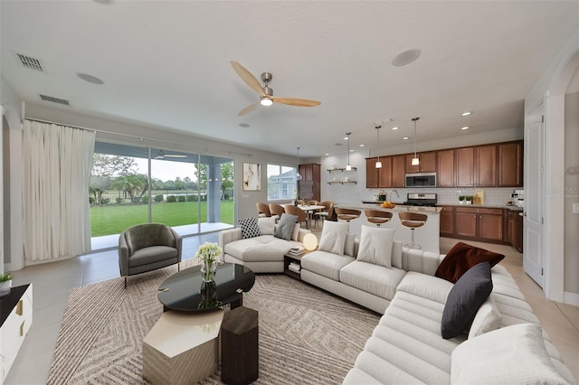 living area with recessed lighting, visible vents, ceiling fan, and light tile patterned flooring