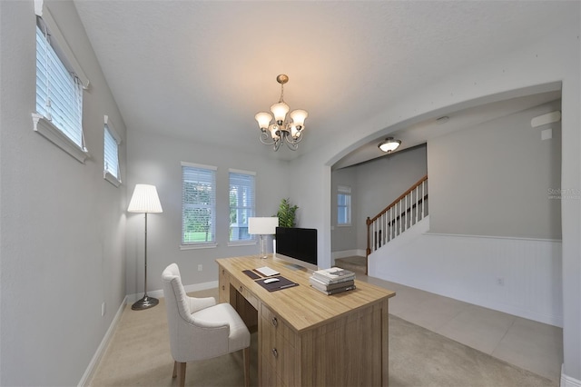 office with baseboards and a notable chandelier