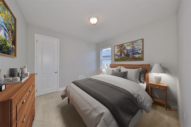 bedroom featuring light carpet and baseboards