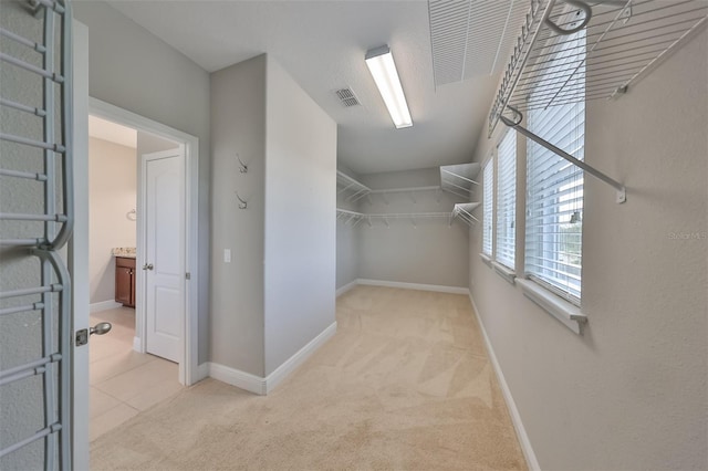 spacious closet with light carpet and visible vents