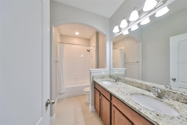 full bathroom with shower / tub combo with curtain, tile patterned flooring, a sink, and toilet