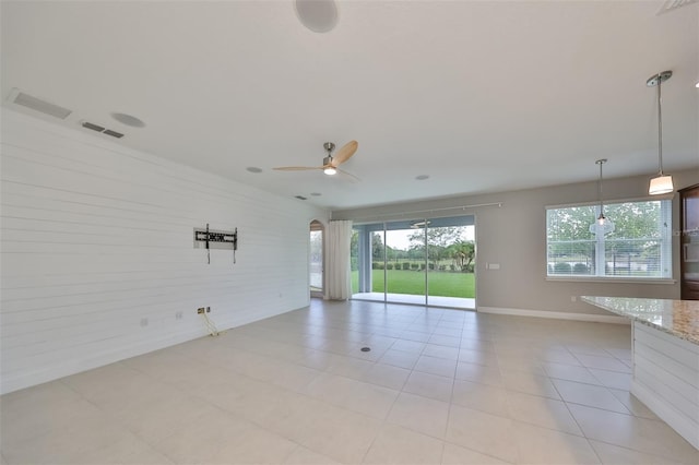 unfurnished room featuring baseboards, visible vents, and a ceiling fan