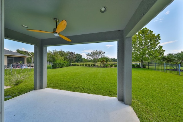 view of patio featuring fence and a ceiling fan