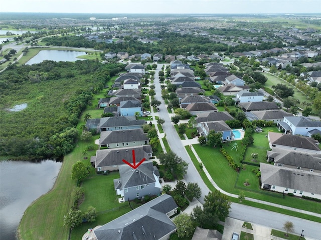 drone / aerial view featuring a residential view and a water view