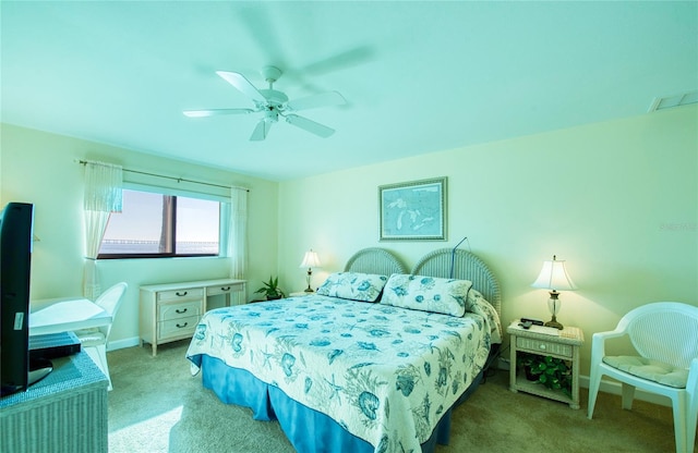 bedroom featuring light colored carpet, visible vents, ceiling fan, and baseboards