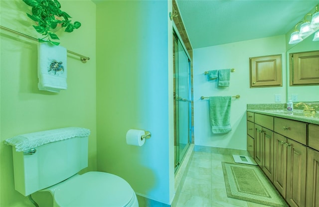 bathroom with tile patterned flooring, a shower stall, vanity, and toilet