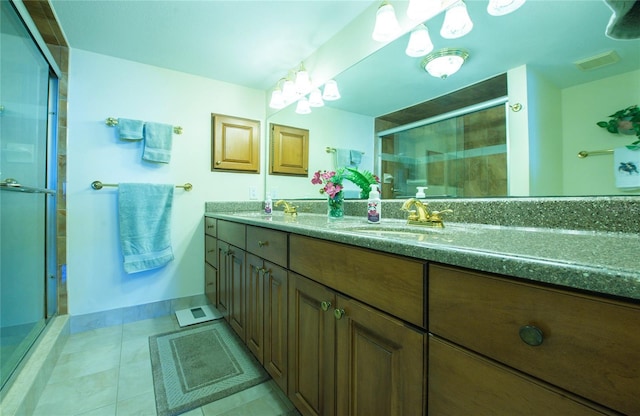 full bathroom featuring double vanity, a stall shower, visible vents, tile patterned floors, and a sink