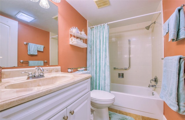 bathroom with visible vents, toilet, tile patterned floors, shower / bath combo with shower curtain, and vanity