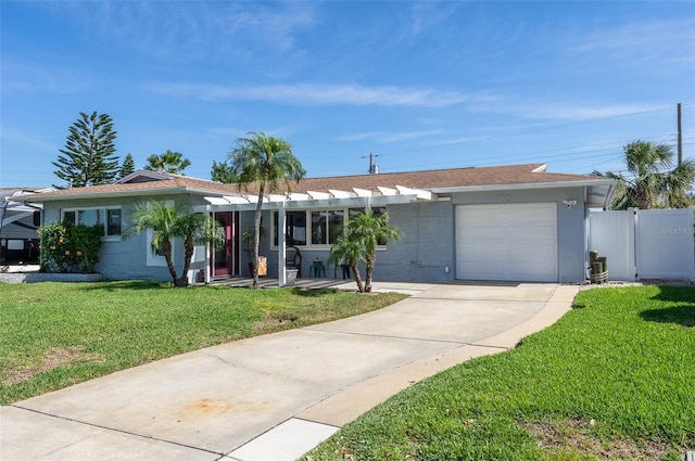 ranch-style home with an attached garage, concrete driveway, and a front yard