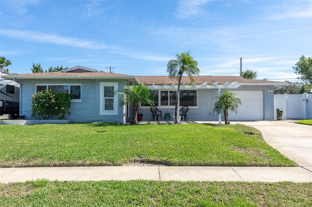 single story home featuring a garage, driveway, a front lawn, and brick siding