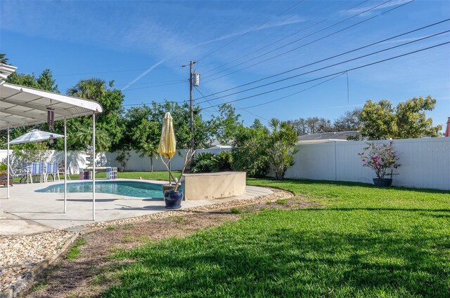 view of pool with a patio, a lawn, a fenced backyard, and a fenced in pool