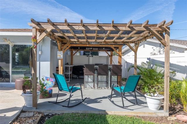 view of patio / terrace with fence, outdoor dry bar, and a pergola