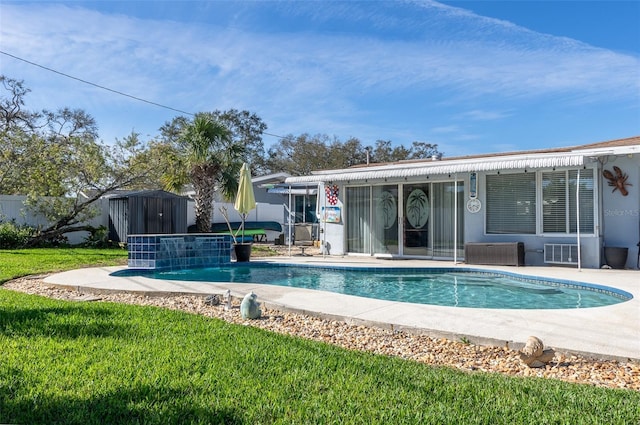 back of house with an outbuilding, stucco siding, visible vents, a storage shed, and an outdoor pool