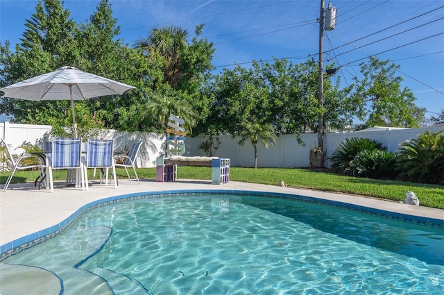 view of pool featuring a patio, a lawn, a fenced backyard, and a fenced in pool