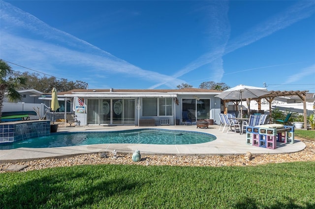 back of property featuring an outdoor fire pit, a patio area, a jacuzzi, and a fenced in pool