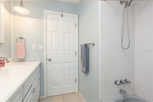 bathroom featuring tile patterned flooring, vanity, and bathing tub / shower combination