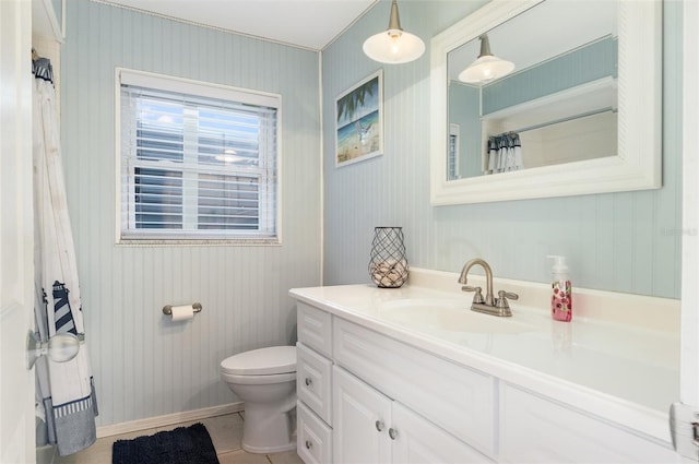 bathroom with toilet, baseboards, and vanity